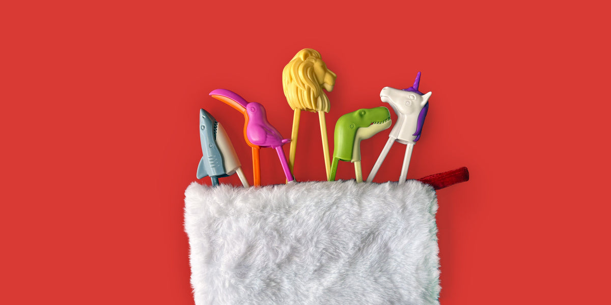 Stocking stuffers for kids - all under $15! Image of a holiday stocking filling with animal-themed chopsticks for kids. Placed on a bright red background.