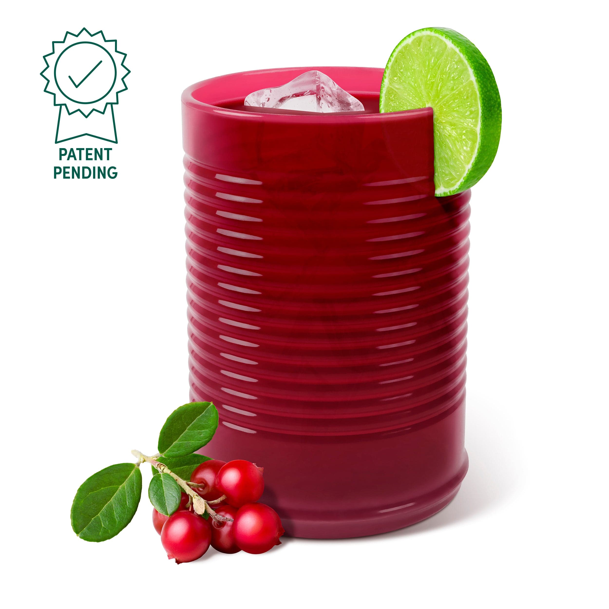 A silicone cup that looks like canned cranberry sauced filled with a cranberry cocktail and a lime garnish on a white background