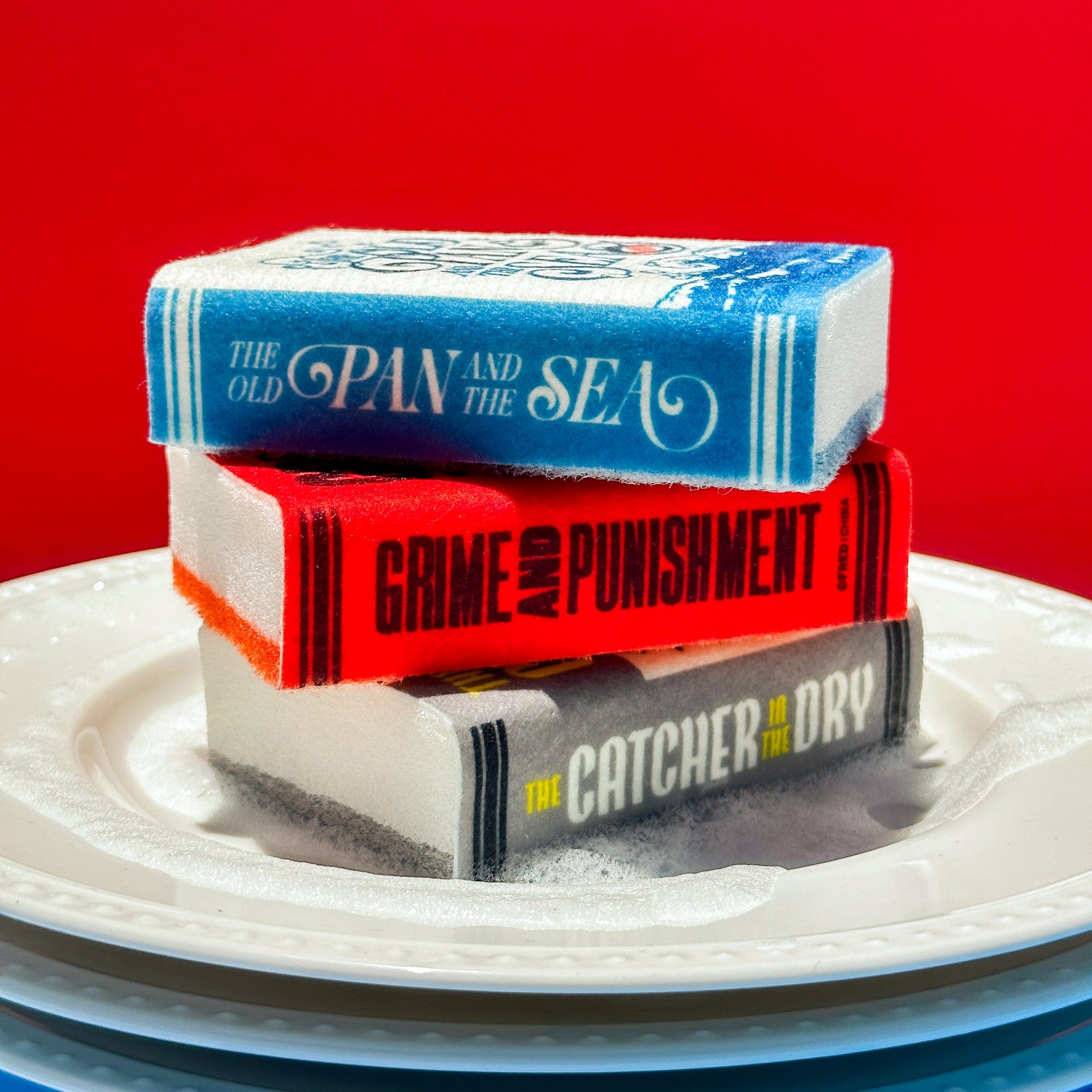 Stack of books on a white plate with a red background