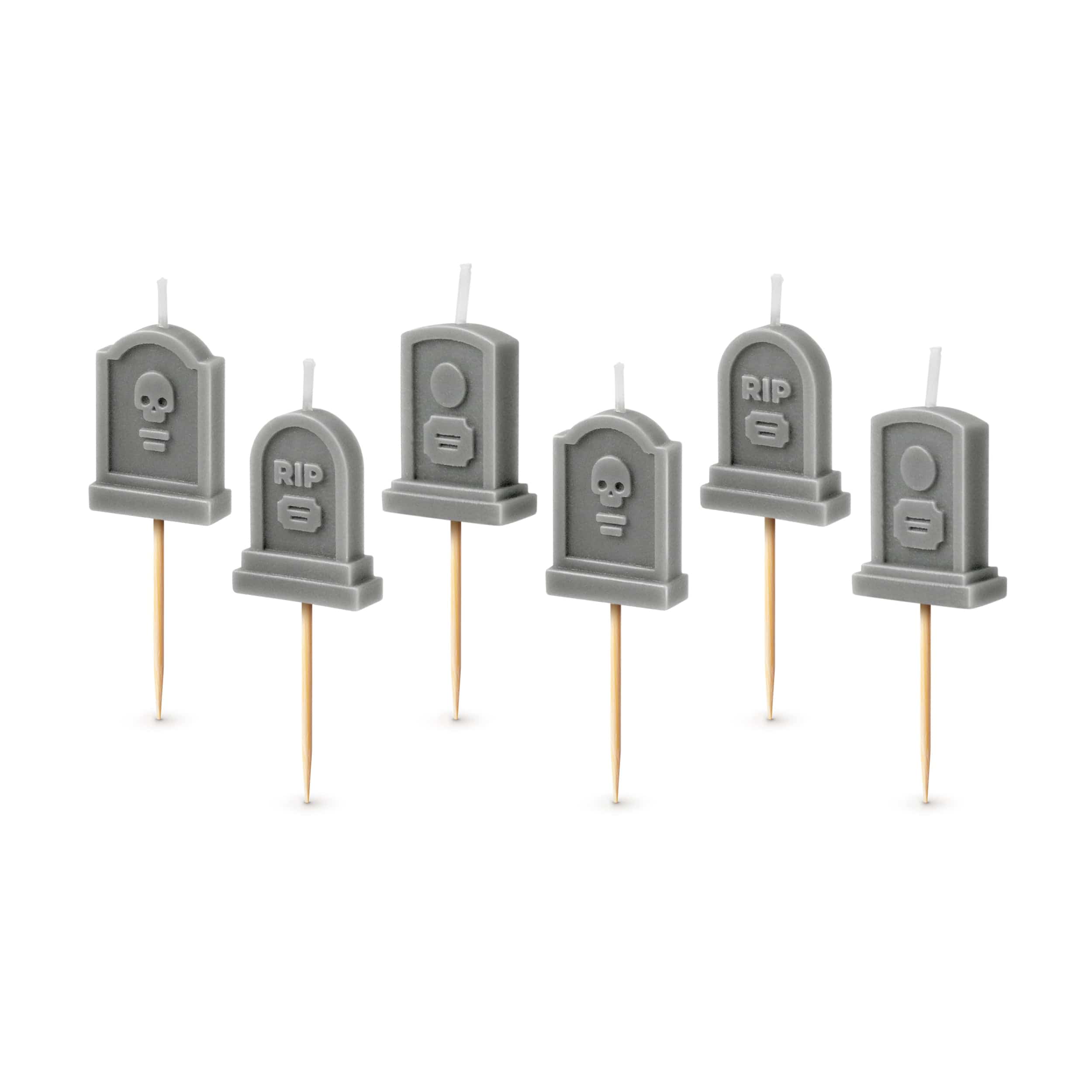 Set of six gray tombstone-shaped candles on sticks with 'RIP' text and skull designs.