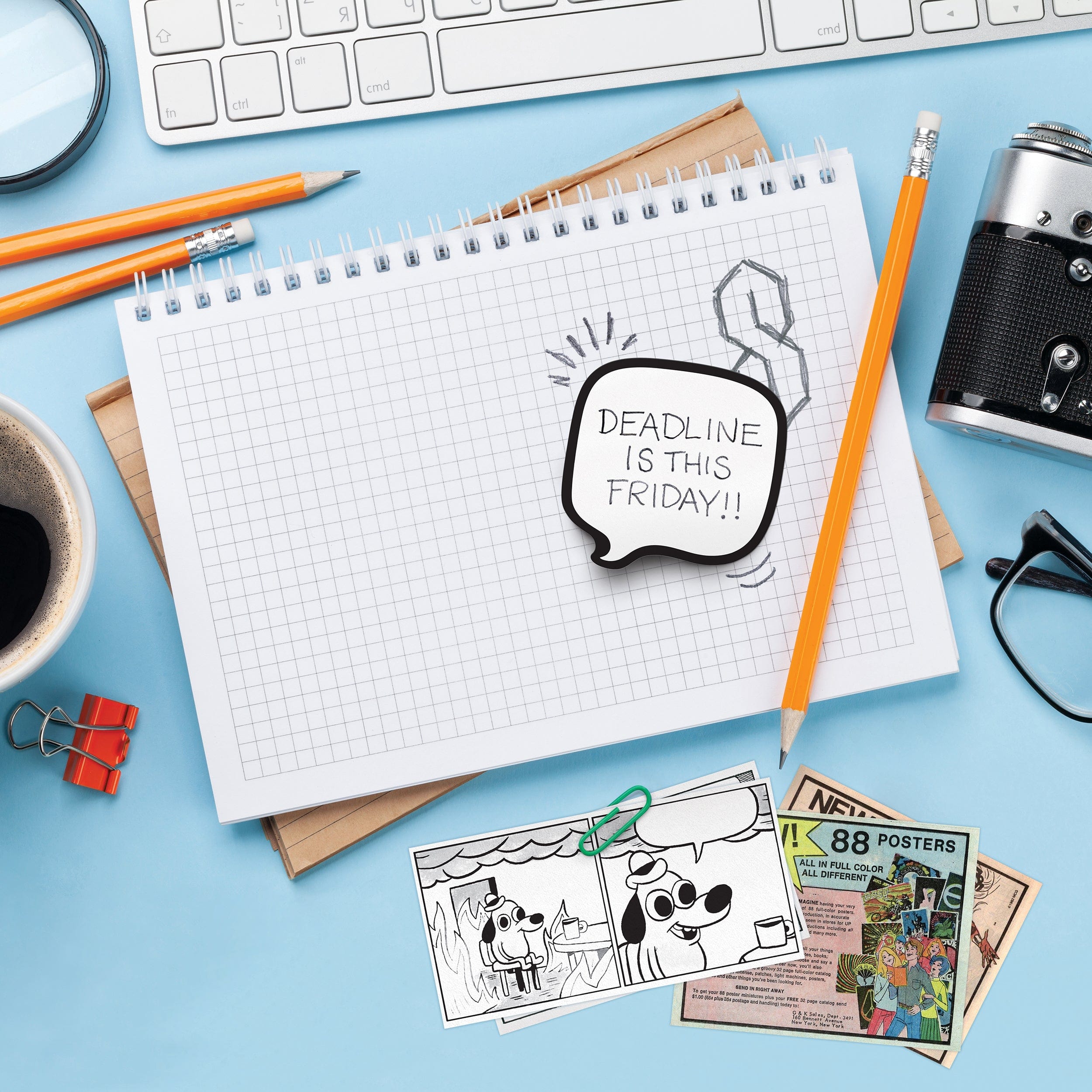 Notebook with a doodle and text 'Deadline is this Friday!' on a desk with stationery items.