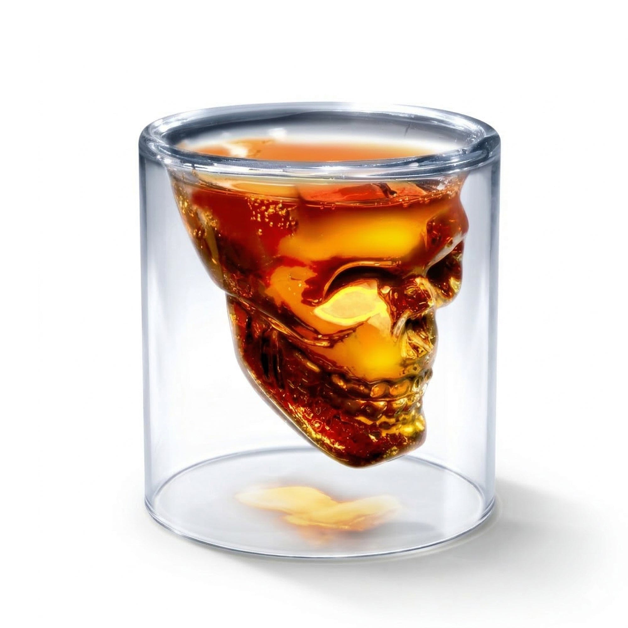 Skull-shaped glass filled with a dark liquid on a white background