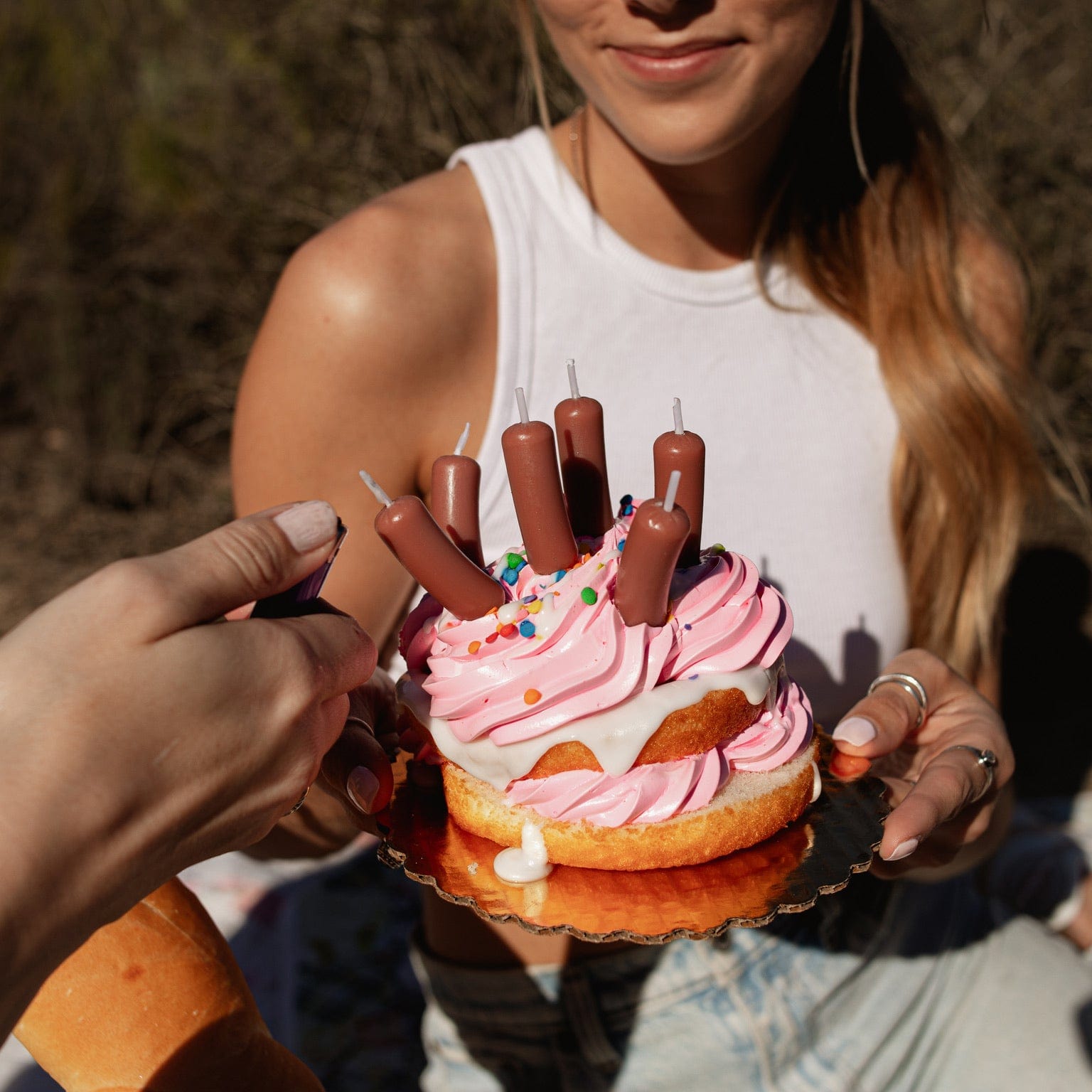 Party candles that look like cocktail wieners on a cake