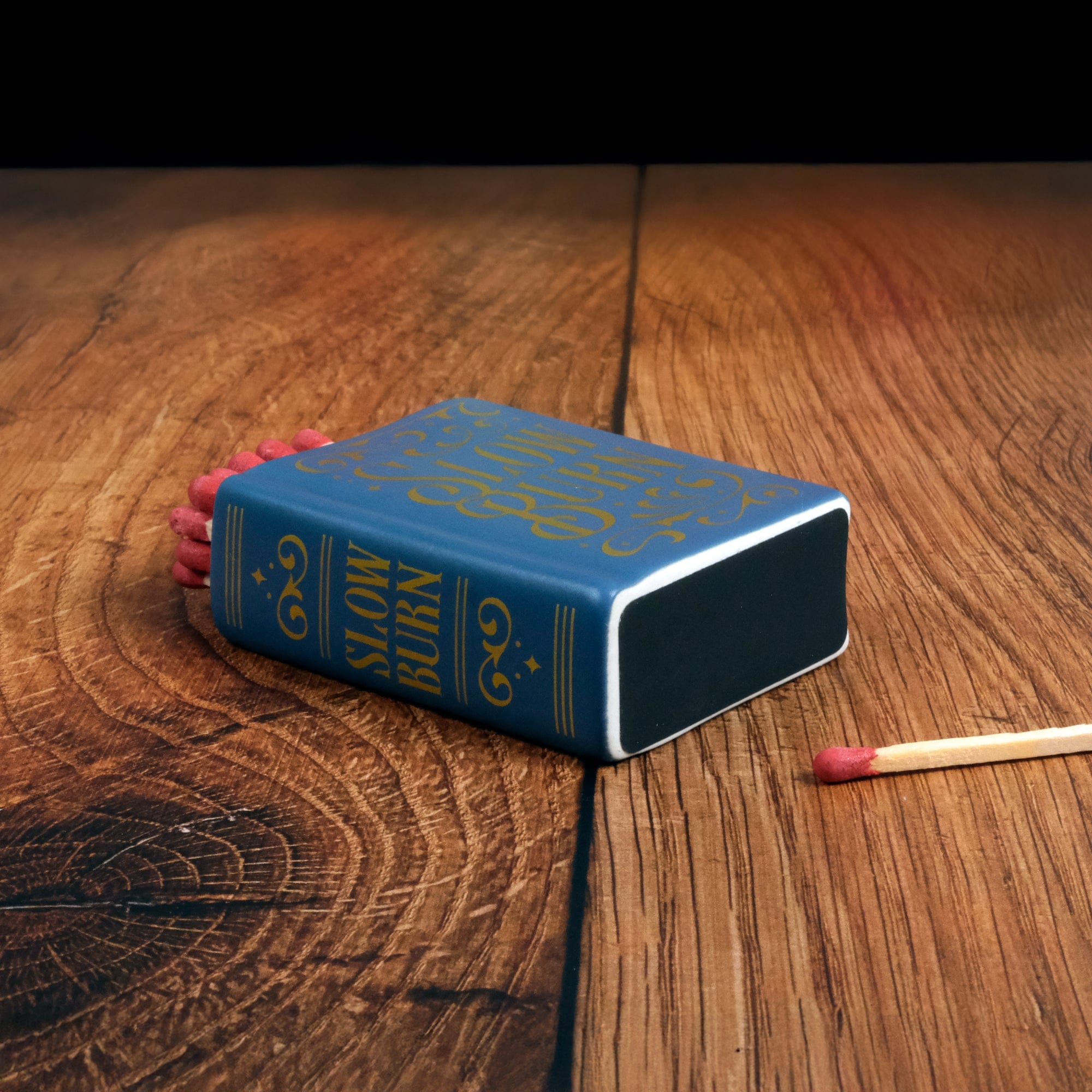 Ceramic book match holder with striker on bottom. Cozy reading gift