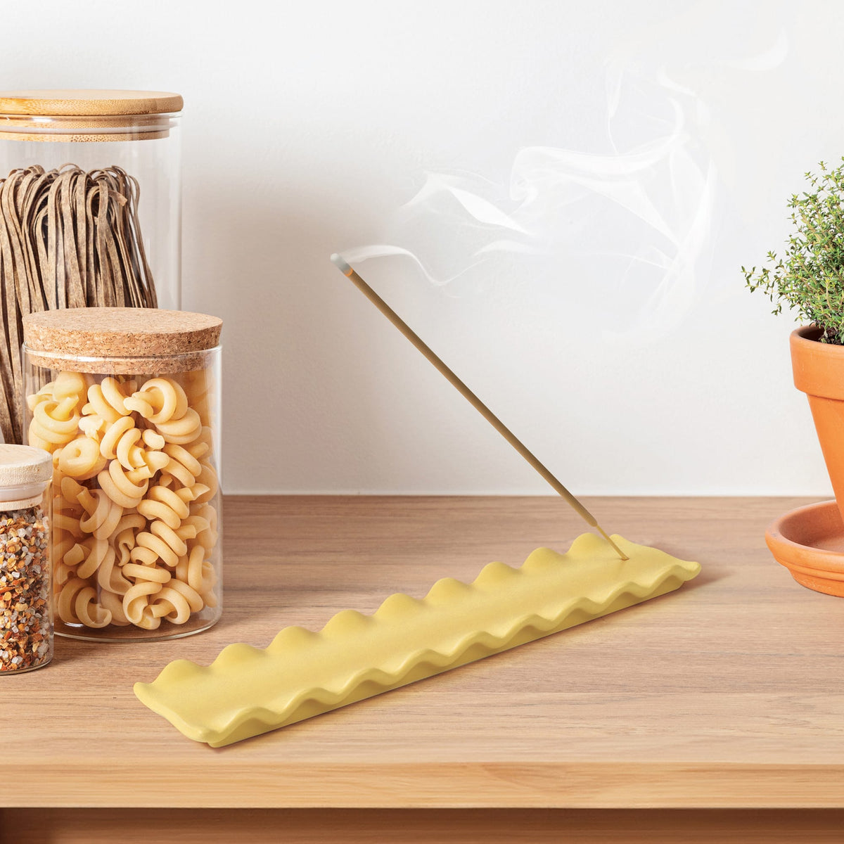 Carb Appeal display featuring glass jar of small pasta shapes with cork lid on a wooden surface