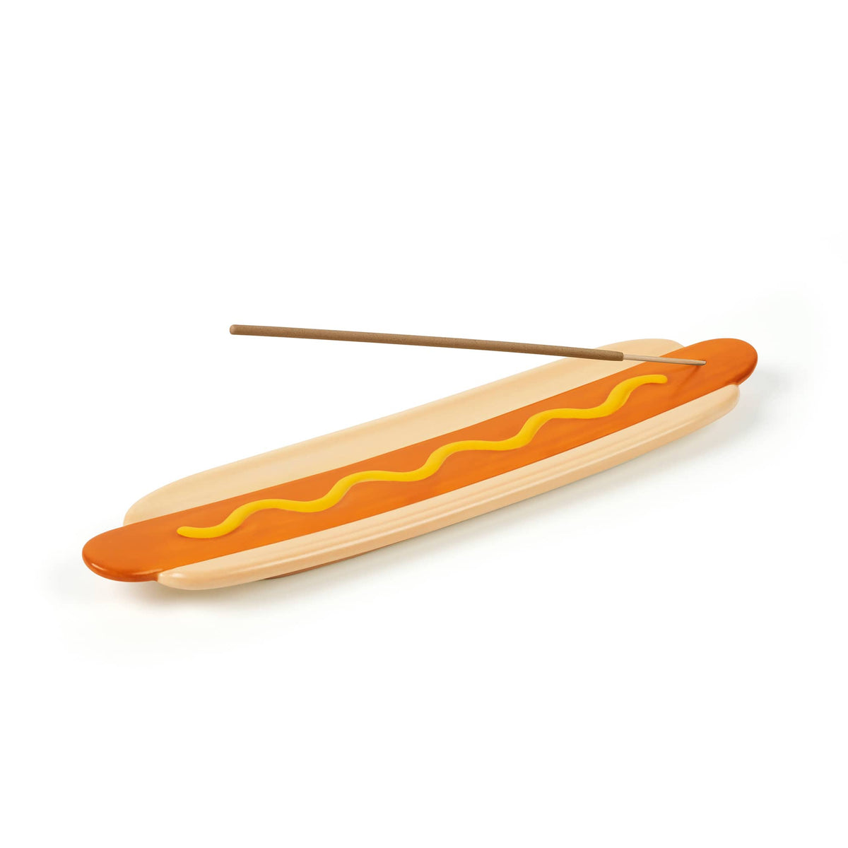 Angled view of the hot dog shaped wooden board with mustard swirl and a chopstick along its length