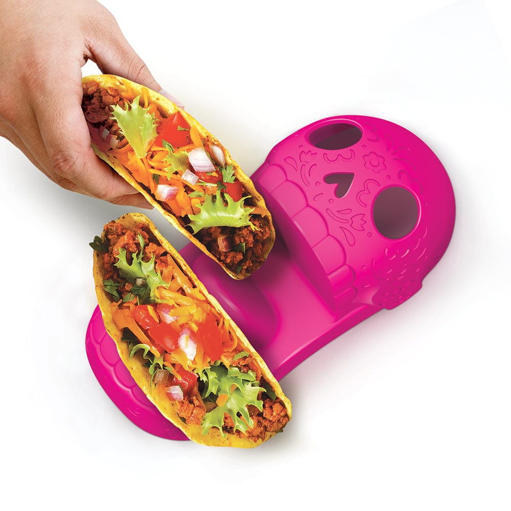 A pink Calavera-style skull taco tray holding two hard shell tacos