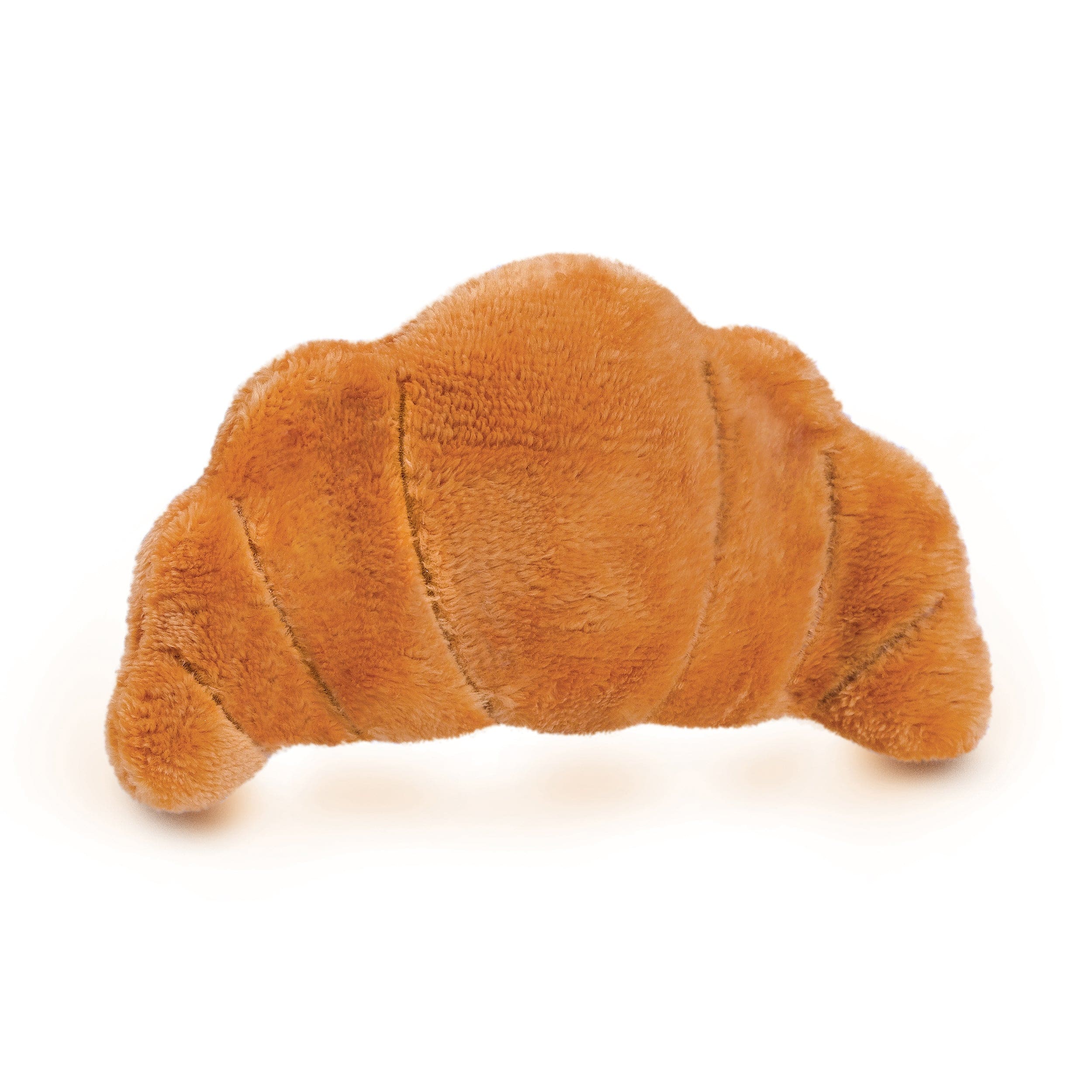 A plush eye pillow that looks like a croissant on a white background