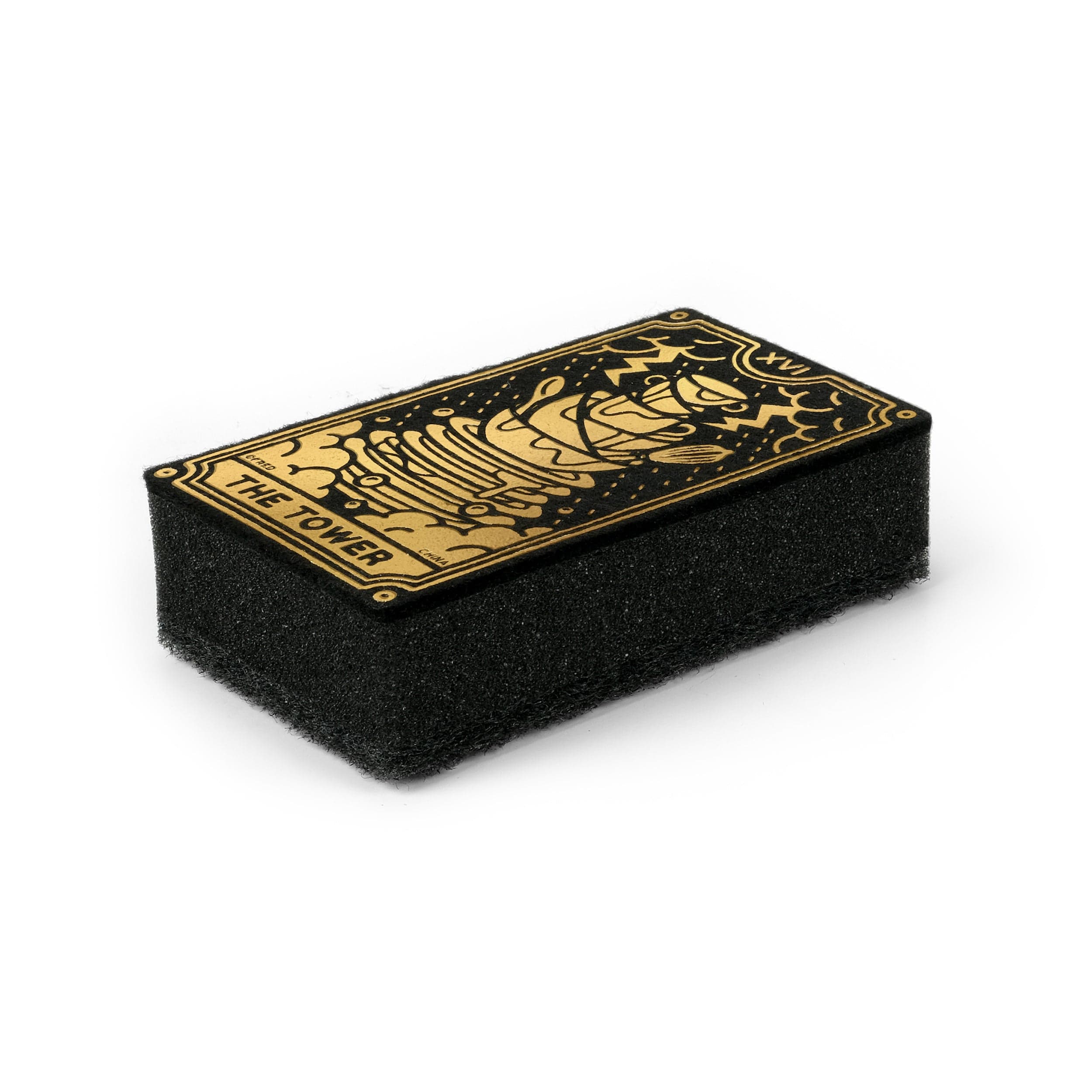 Black and gold tarot card sponge that says "The Tower" with a stack of dishes design on a white background
