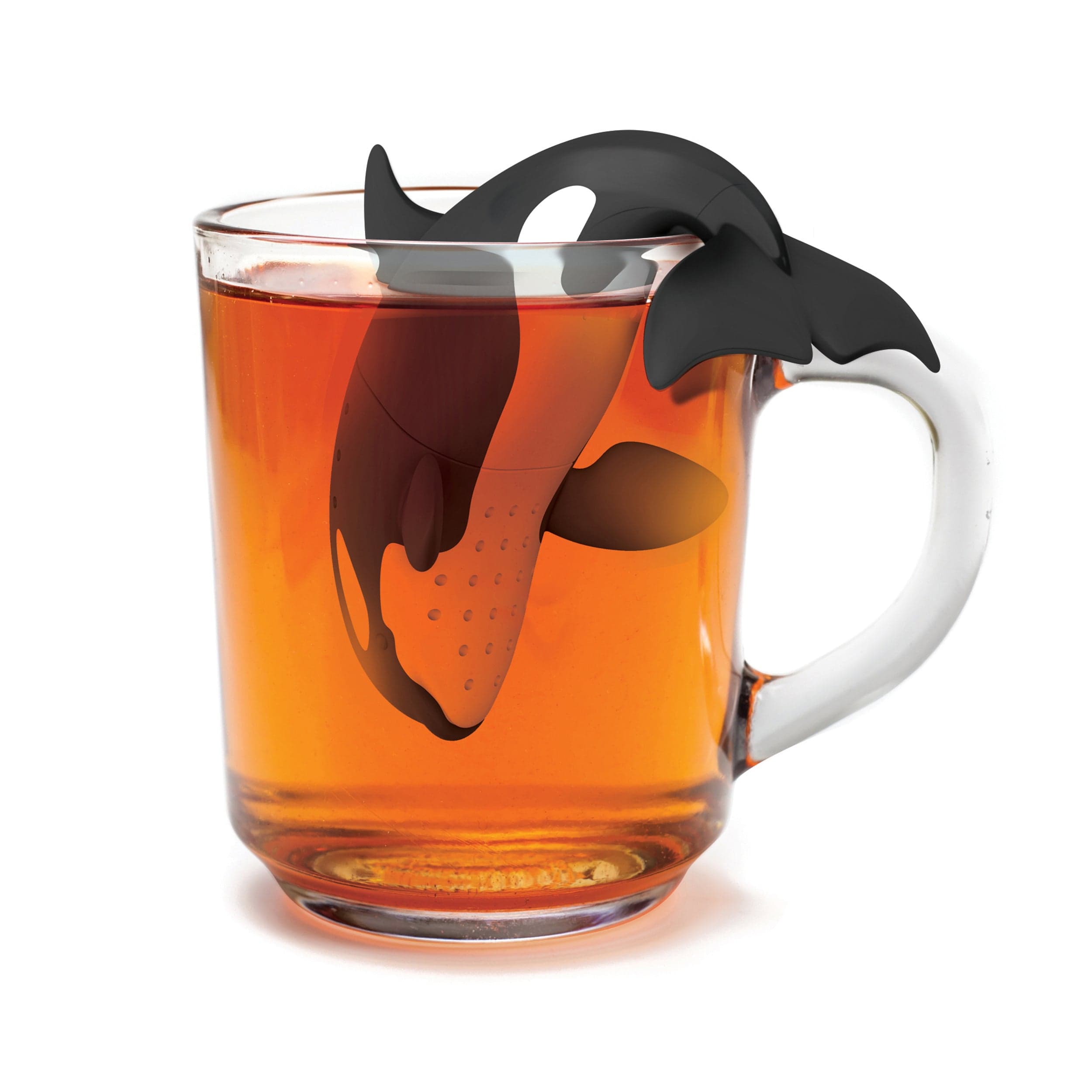 Tea infuser shaped like an orca whale in a glass of tea on a white background