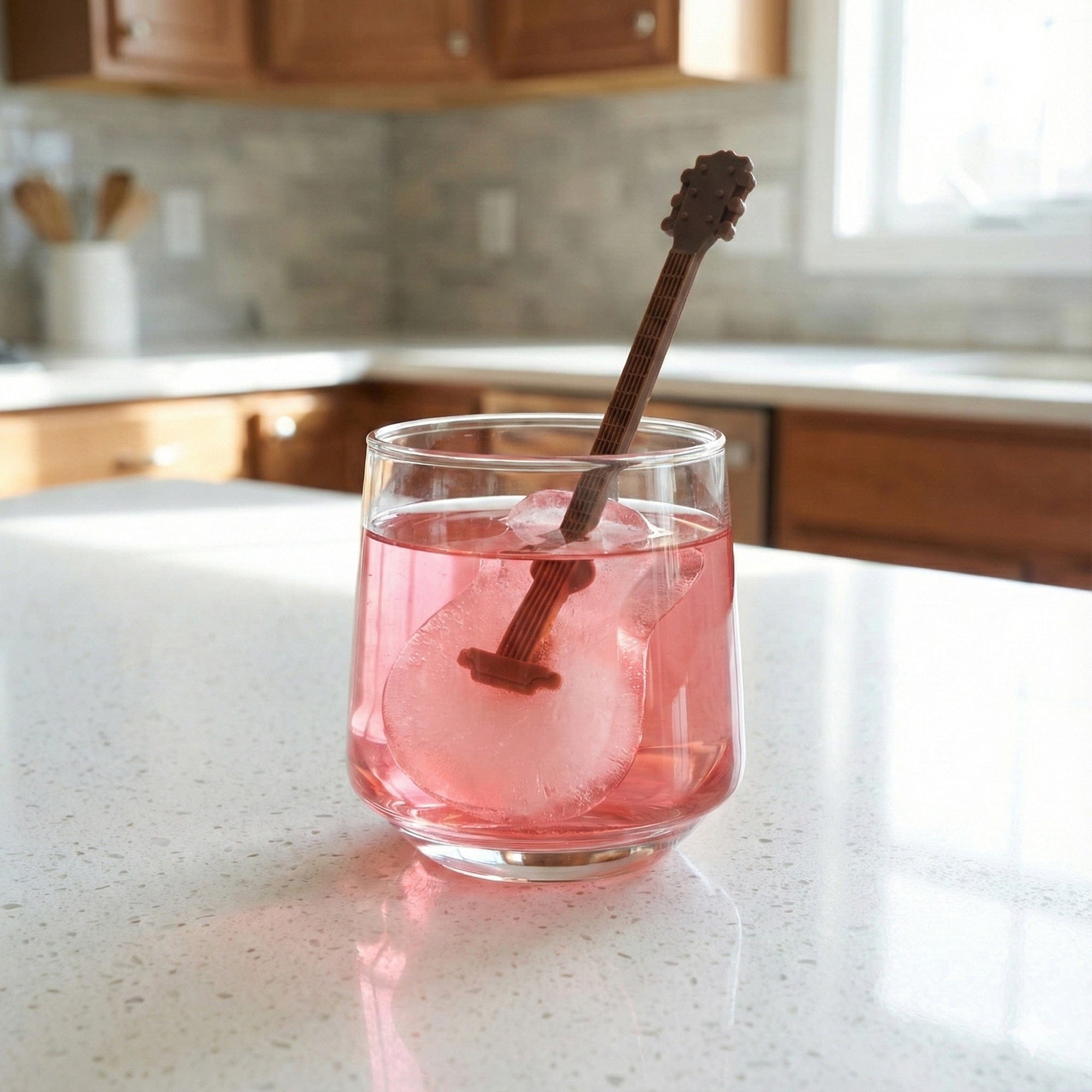 Pink guitar ice stirrer in a cocktail glass, unique party favor for Dolly Parton themed bachelorette parties