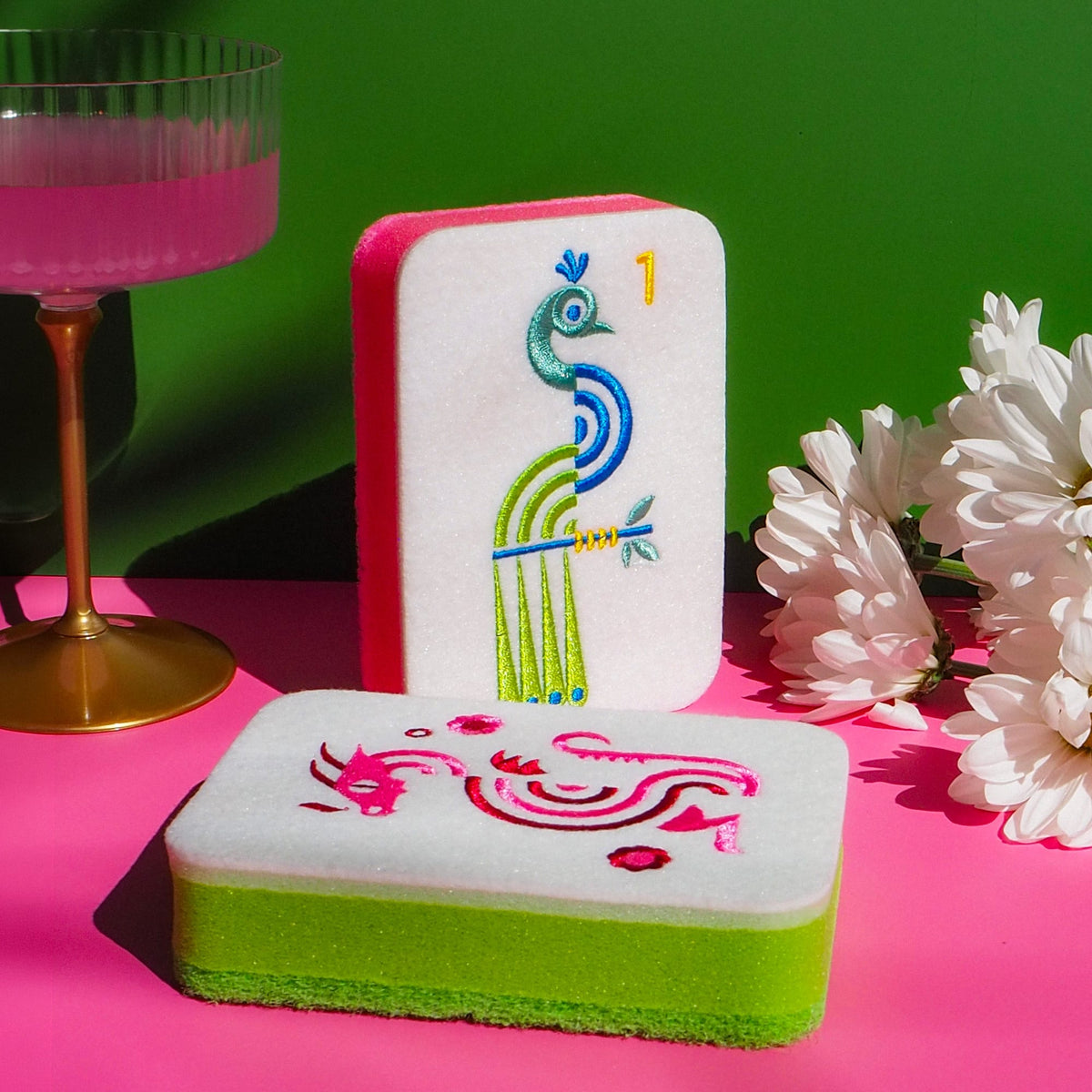 Close-up of embroidered mahjong tile sponge designs with colorful stitched details