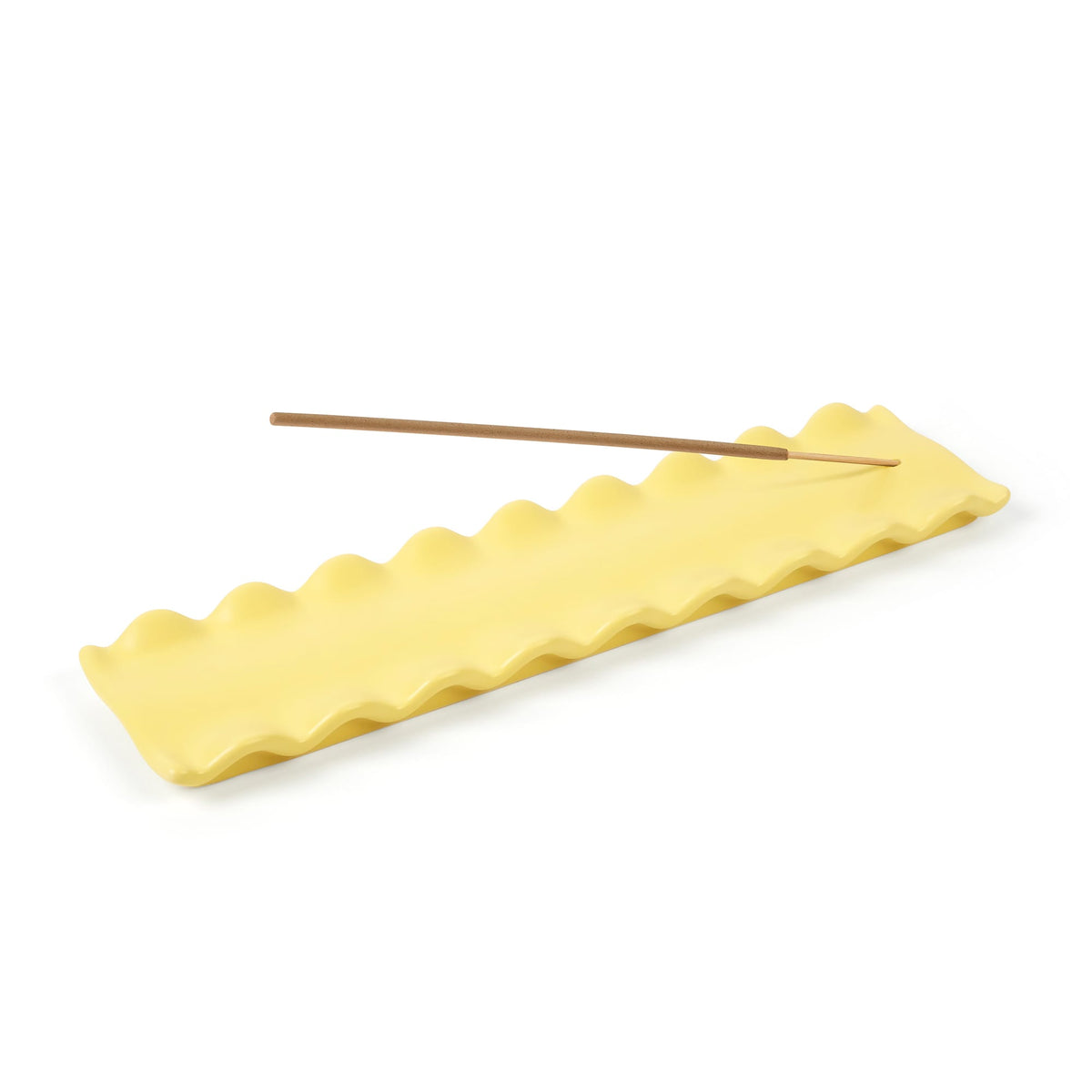 CARB APPEAL yellow wavy edge silicone mat with a long wooden stick resting on top