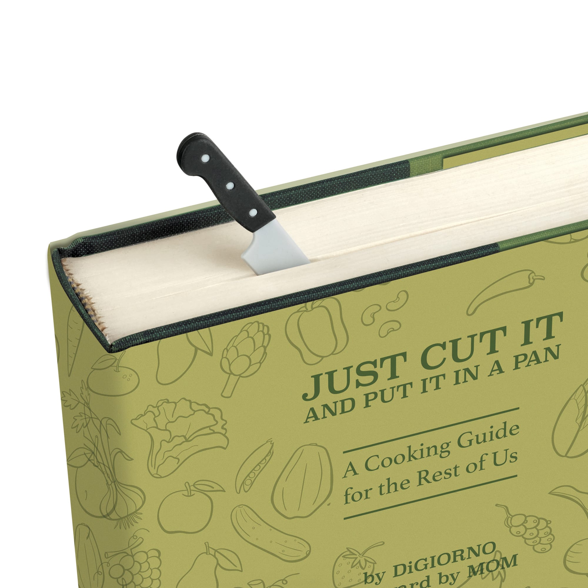 A close-up of a hardcover cooking guide book titled "JUST CUT IT AND PUT IT IN A PAN" with a small kitchen knife bookmark  tucked under the open top edge. The cover is light olive green with subtle food illustrations and dark green text.