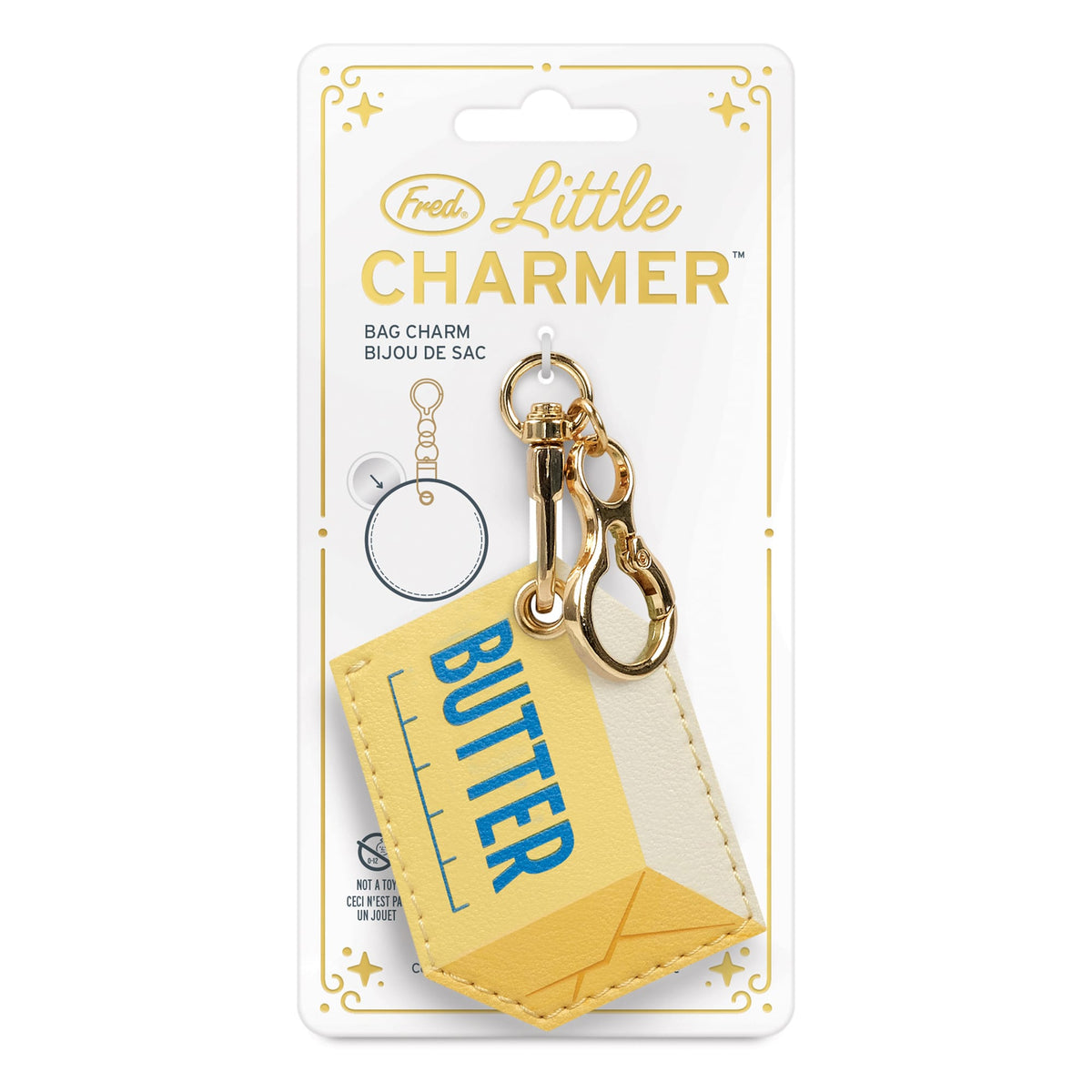 Butter design Little Charmer bag charm displayed on a gift-ready gold foil card. The perfect holiday gift or stocking stuffer for $10.