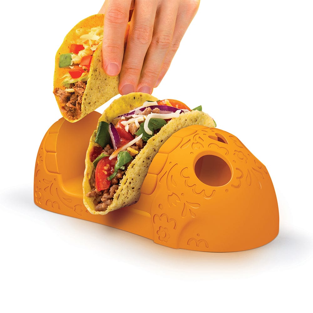 An orange Calavera-style skull taco tray holding two hard shell tacos